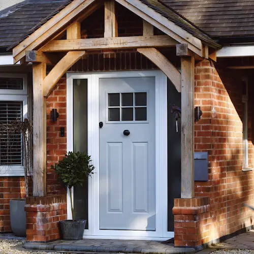 Photo of the front of a house, zoomed into the light blue wooden door